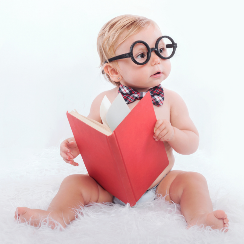 Cute baby reading a book